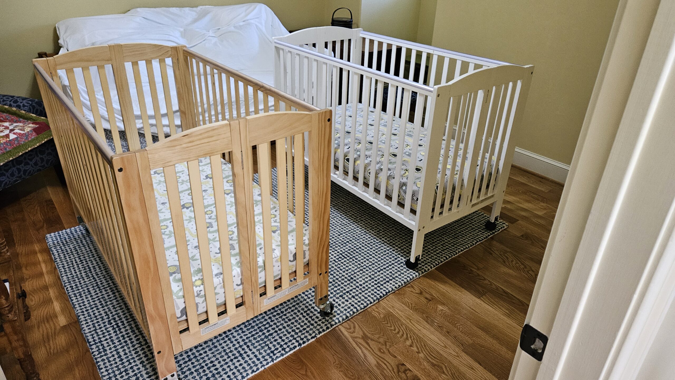 Two cribs side by side